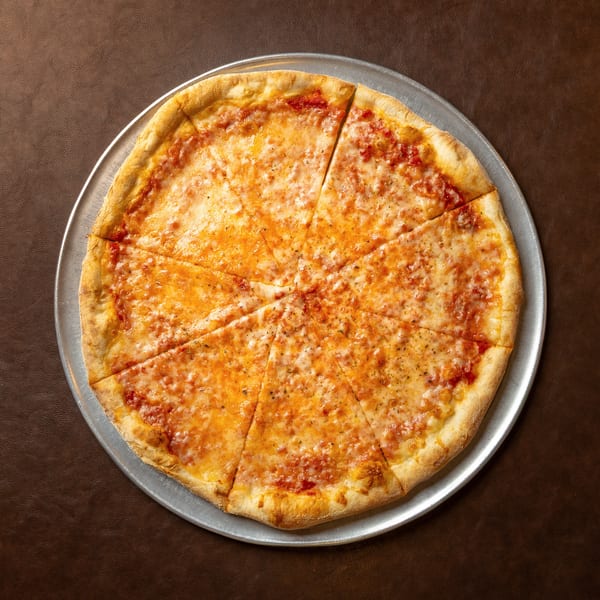 Whole cheese pizza sliced into wedges on a metal tray atop a brown leather-textured surface.